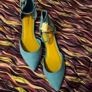 Powder blue pointed flats with ankle strap.